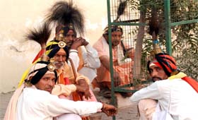 A group of jangams in their trademark head gear rest near Hanuman Chowk on Monday. The jangams are known to visit the households seeking alms, especially at the time of festivals.