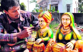 A Bengal-based artiste gives finishing touches to terracota sculptures in view of the upcoming Divali festival season in Haridwar on Monday.