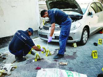 Policemen inspect the site of an explosion in Manama.