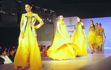 Models exhibit designer wear during a fashion show at Club Cabbana near Jalandhar on Sunday.