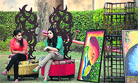 Students of Apeejay College of Fine Arts sit on their designer chairs during an exhibition at Gymkhana Club in Jalandhar on Monday. 