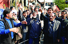 Members of the All-Kashmir LPG Distributors Association protest in Srinagar on Monday. 