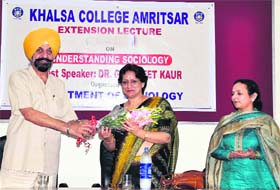 Dr Daljit Singh, Principal, Khalsa College, welcomes Dr Gurpreet Kaur Bal from the Sociology Department of Guru Nanak Dev University during a seminar at the college in Amritsar