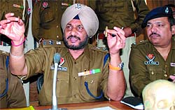SSP Ravcharan Singh Brar shows the bullet that killed a woman on the night of Karva Chauth, at the District Administrative Complex in Bathinda on Tuesday
