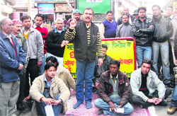 Social activists and local film artistes hold a dharna in protest against the movement of vehicles on Mall Road in Mussoorie on Tuesday following the death of a Bengali tourist.