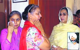 Relatives of Lajwant Singh (inset), who committed suicide by shooting himself at his residence in Urban Estate, Phase-I, mourn his death in Jalandhar on Tuesday