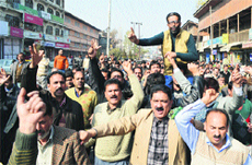 State government employees raise slogans during a protest in Srinagar on Tuesday. 
