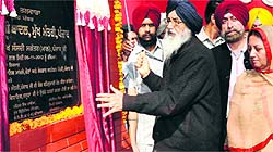 Chief Minister Parkash Singh Badal lays the foundation stone of an Adarsh School in Talwara. Dasuya MLA Sukhjit Kaur Sahi is also seen