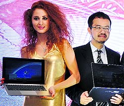 Asus India MD Alex Huang (R) at the launch of the Taiwanese computer majors Windows 8 dual touch screen ultrabooks, tablet and notebooks in India in New Delhi on Wednesday. Asus ultrabooks are priced from Rs 139,999 to Rs 61,999