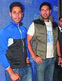 Cricketer Yuvraj Singh and captain of West Bengal Ranji team Manoj Tiwary at Sector 17, Chandigarh, on Wednesday