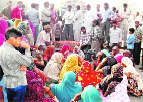 Villagers block the Cheeka-Kaithal road by laying the body of the girl shot on Wednesday