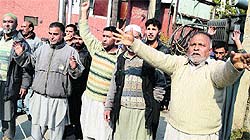 Kashmiri shopkeepers having their businesses in Leh protest against the Leh administration in Srinagar on Wednesday