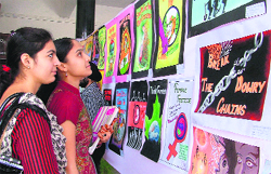 Students look at paintings at an art exhibition held on the occasion of the Legal Literacy Youth Festival at SCD Government College in Ludhiana on Wednesday. photo: inderjeet verma