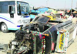 An auto lies overturned after an accident that occurred near the Jagraon bus stand on Wednesday.