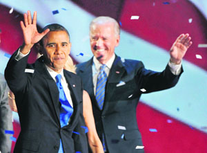 President Barack Obama and Vice-President Joe Biden (R) celebrate at the election night victory rally in Chicago.