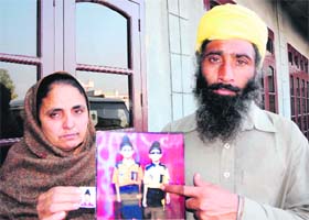 The parents of Gurkirat Singh, who went missing from his house on Wednesday, show his photograph at their residence in Verka on Thursday