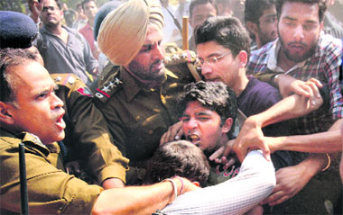 Police personnel try to stop protesting students from entering the VC's office; and (below) a broken sculpture on the PU campus on Thursday.