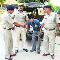Sandeep, one of the accused in the Kaithal firing incident, being taken to court on Thursday. 