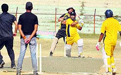 Players in action during the Eid Diwali Milan cricket cup at MA stadium