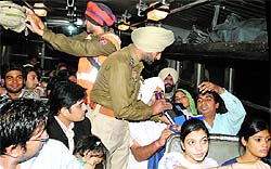 Police personnel check luggage of bus passengers in Jalandhar on Thursday