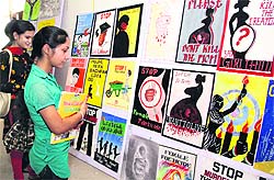 Students have a look at paintings put up at the Khalsa College for Women in Jalandhar on Thursday