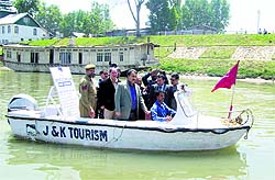 Officials of the Department of Health reviews the water transport facility in the Jhelum in Srinagar on Thursday