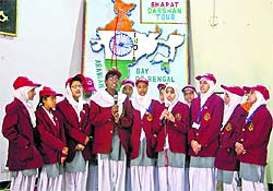 A group of girl students present a song during the reception function in Srinagar