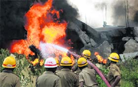 Firefighters douse a blaze that erupted in a paint factory in Bangalore on Thursday