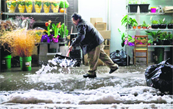 A man shovels snow caused by a storm in New York.