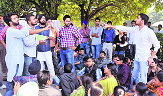 Students of various organisations argue during the protest against hike in mess charges outside the Panjab University VC 's office on Friday.