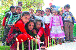 Students light candles during the Divali celebrations in Ludhiana on Friday.