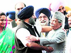 Sukhbir Badal hugs Pakistan Punjab Assembly Speaker Rana Muhammad Iqbal Khan as Harsimrat Kaur looks on in Wagah on Friday