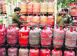 Police personnel with the seized cylinders