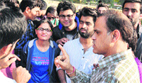 Chandigarh DSP Ashish Kapoor pacifies the agitating students outside the VCs office at Panjab University. Tribune photo: Pradeep Tewari