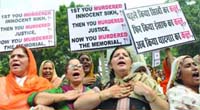 Activists of the SAD (Badal) shout slogans during a protest against Chief Minister Sheila Dikshit for scuttling the move to name the 1984 Sikh Memorial Park, outside her residence in New Delhi on Saturday
