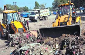 A cleanliness drive being carried out in Haridwar on Saturday to dispose of garbage collected by volunteers of the Dera Sacha Sauda