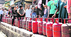 Srinagar residents await their turn for LPG refills.