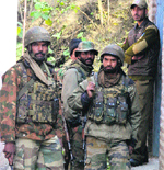 Army men wait outside a hospital to collect the body of Lt Col Sarang Apte in Bandipore on Saturday. Tribune photo: Amin War