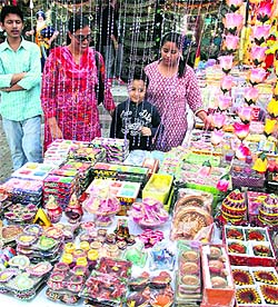 Customers take a took at torans, diyas and candles at a shop in Jalandhar