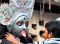 An artist gives finishing touches to an idol of Goddess Kali ahead of Divali in Allahabad on Saturday