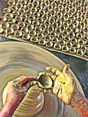 A potter busy in making earthen lamps ahead of Divali at Narayanpur in Birbhum district of West Bengal