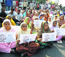 Family members of kidnapped 10-year-old Gurkirat Singh protest against the police at Verka in Amritsar on Sunday.