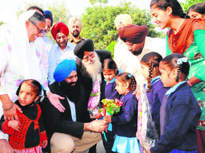 Meeting the special ones: Children greet Canadian Minister Tim Uppal (blue turban) during his visit to Pingalwara in Amritsar on Sunday.