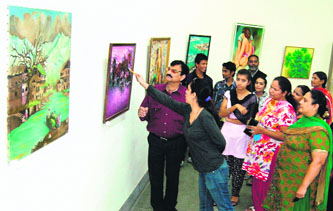 Visitors take a look at the paintings at the ongoing art exhibition at Thakar Singh Art Gallery in Amritsar.