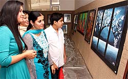 Visitors have a look at the work on display at the Civil Lines Club on Sunday