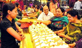 People buy gold jewellery on the occasion of Dhanteras in Sector 34, Chandigarh, on Sunday.