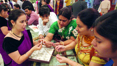 Women purchase jewellery at Karol Bagh Market on the occasion of Dhanteras, in New Delhi on Sunday. 