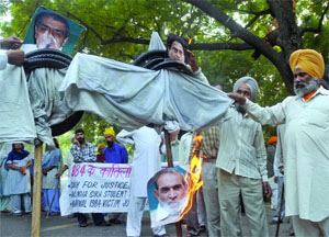 Activists burn the effigies of Sajjan Kumar, Kamal Nath and Jagdish Tytler during a demonstration at Jantar Mantar in New Delhi on Sunday.