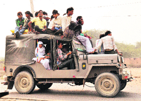People travel on an overloaded jeep putting their lives at risk in Mewat.