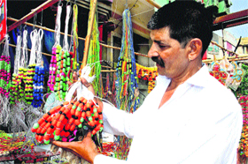 With Divali round the corner, a shopkeeper displays decorative items at his shop in Sonepat. 